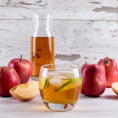 side-view-apple-juice-white-wooden-table